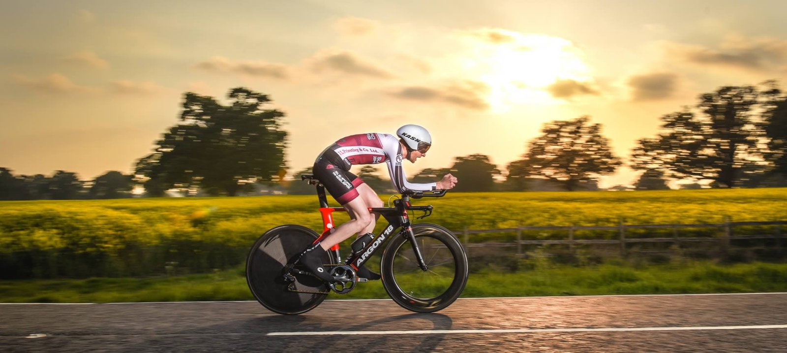 Richard Hamblin in the zone on a TT bike with the sun going down behind him